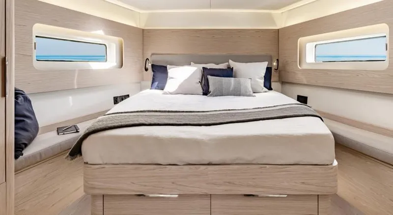 Slide: The Image of Luxurious bedroom interior of 2025 Beneteau Oceanis Yacht 54 with modern design and cozy bedding. - 22