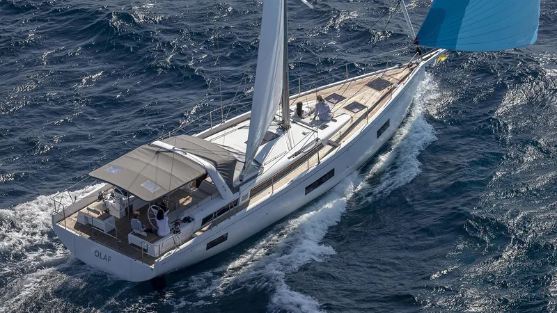 Slide: The Image of 2025 Beneteau Oceanis Yacht 54 sailing on open sea with blue spinnaker. - 23