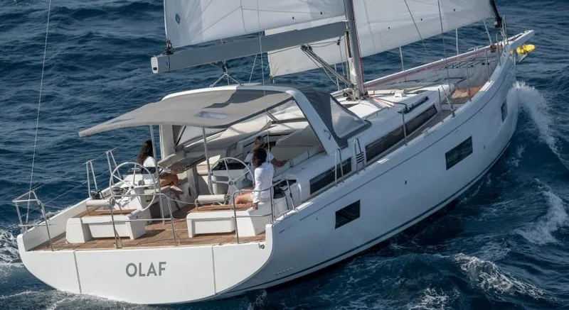 Slide: The Image of 2025 Beneteau Oceanis Yacht 54 sailing on open sea, featuring sleek design and spacious deck. - 24
