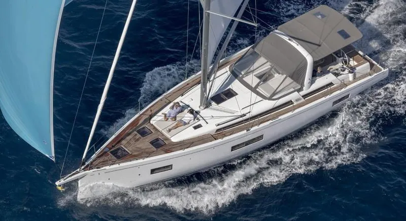 Slide: The Image of 2025 Beneteau Oceanis Yacht 54 sailing on open water, top view. - 25