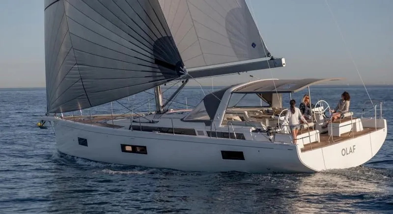 Slide: The Image of 2025 Beneteau Oceanis Yacht 54 sailing on open water, featuring sleek design and spacious deck. - 26