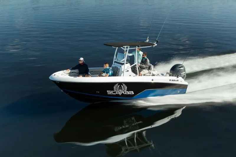 The Image of 2025 Wellcraft 202 Fisherman boat cruising on calm water with passengers. - 0