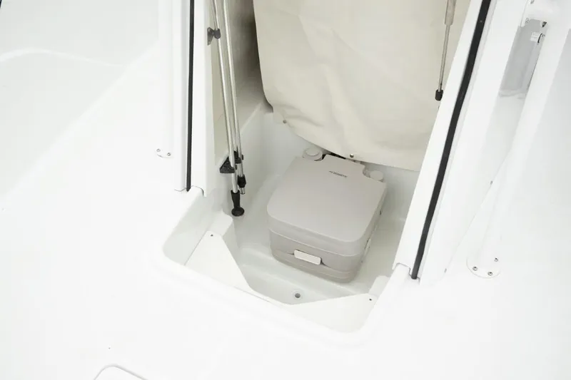 Slide: The Image of 2025 Wellcraft 202 Fisherman boat interior with portable toilet. - 14
