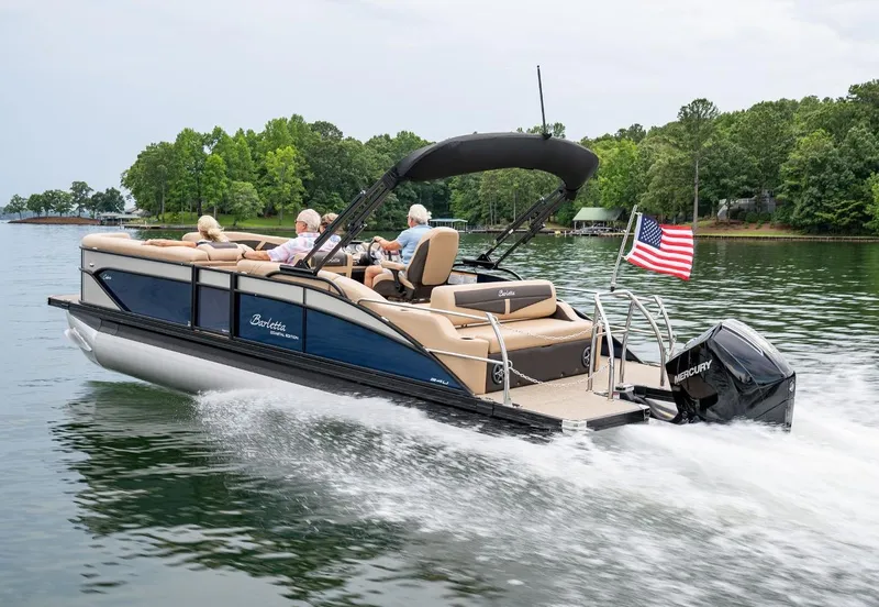Slide: The Image of 2025 Barletta Cabrio 24UC pontoon boat with passengers relaxing on comfortable seating. - 13