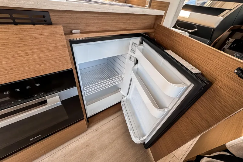 Slide: The Image of Interior of Wellcraft 44 Explorer 2026 with open refrigerator. - 12