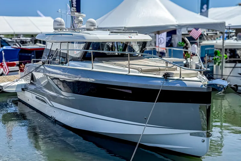 Slide: The Image of 2025 Wellcraft 44 Explorer yacht cruising on open water under cloudy skies. - 42