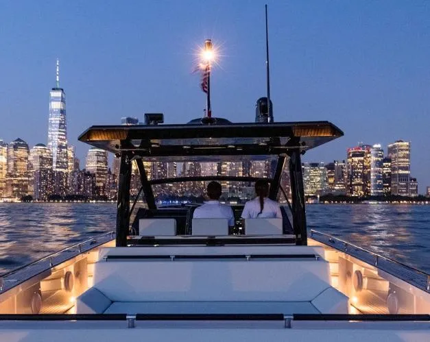 Slide: The Image of Windy SR52 yacht cruising at night with city skyline in the background, 2025 model. - 10