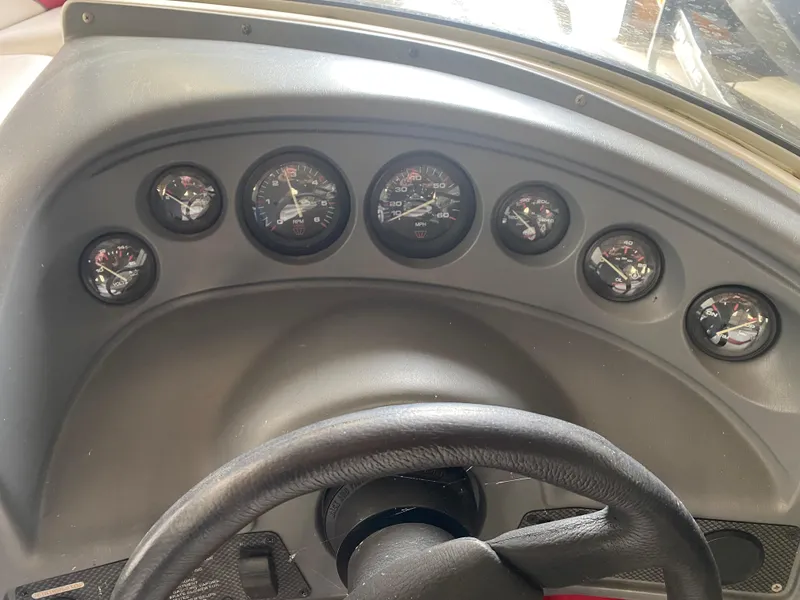Slide: The Image of Dashboard of a 1995 Wellcraft 196 S Eclipse boat with multiple gauges. - 21
