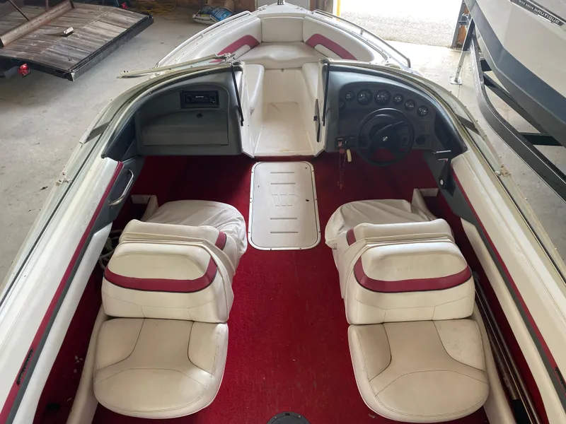 Slide: The Image of 1995 Wellcraft 196 S Eclipse boat interior with red carpet and white seats. - 22