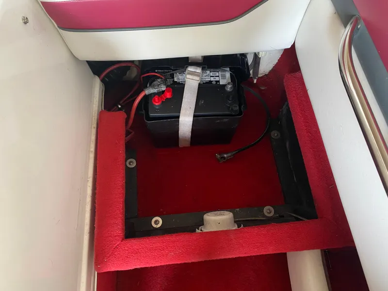 Slide: The Image of Battery compartment of 1995 Wellcraft 196 S Eclipse boat with red carpet interior. - 28