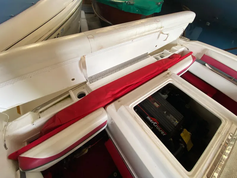 Slide: The Image of 1995 Wellcraft 196 S Eclipse boat interior with red accents and visible engine compartment. - 29