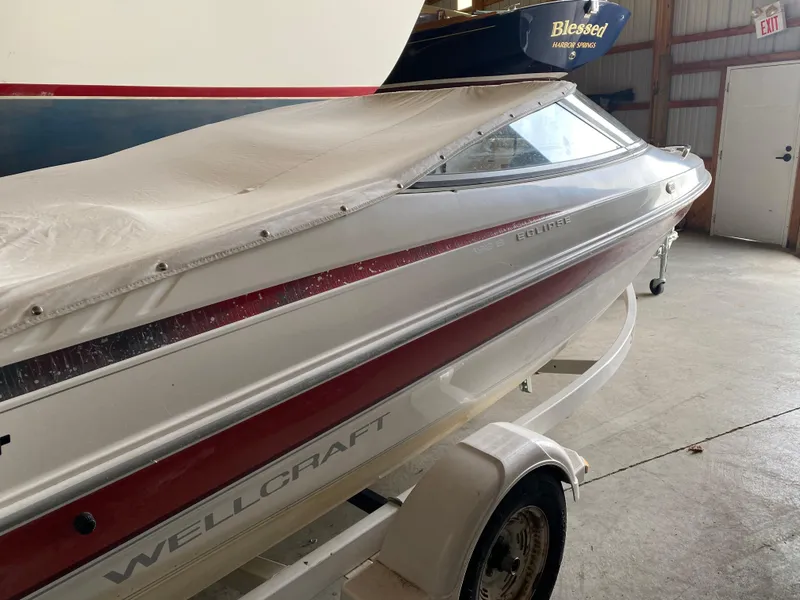 Slide: The Image of 1995 Wellcraft 196 S Eclipse boat in storage, covered and on a trailer. - 3