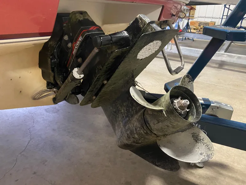 Slide: The Image of 1995 Wellcraft 196 S Eclipse boat propeller and outdrive in a garage setting. - 31