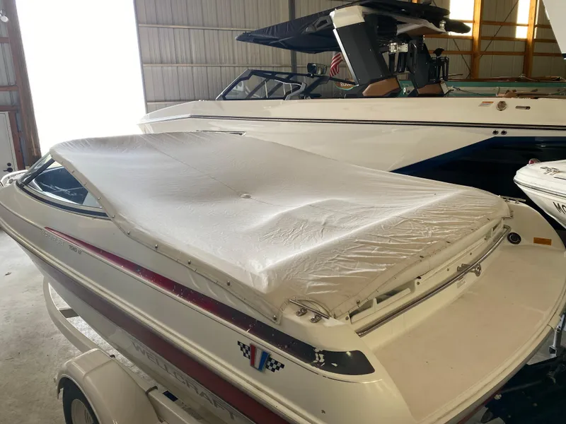 Slide: The Image of 1995 Wellcraft 196 S Eclipse boat covered in storage, side view. - 5