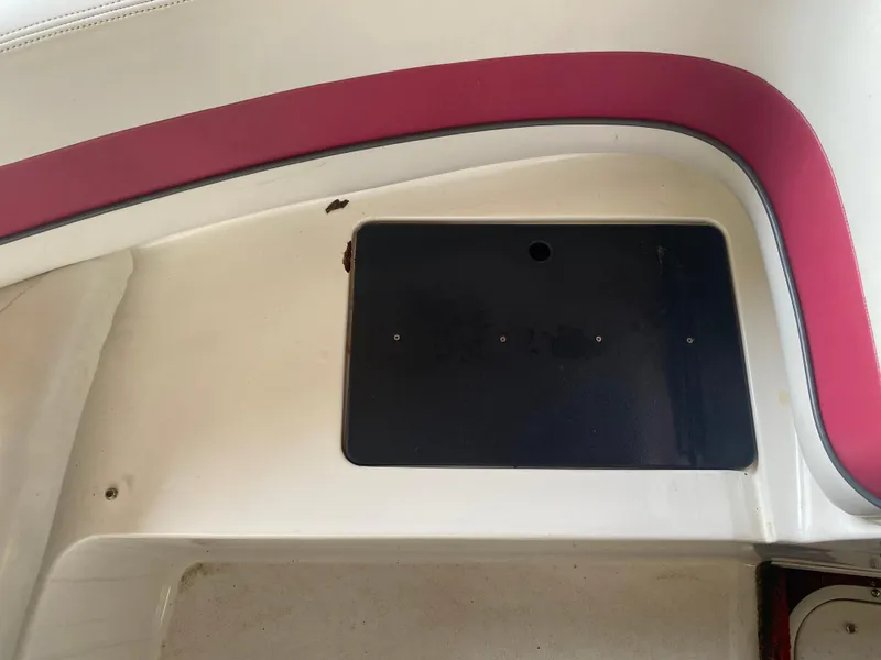 Slide: The Image of Interior of a 1995 Wellcraft 196 S Eclipse boat with red trim and storage compartment. - 7