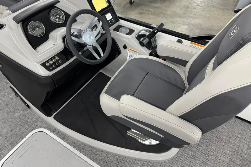Slide: The Image of 2025 Barletta Cabrio 24UC boat interior with steering wheel and captain's chair. - 12