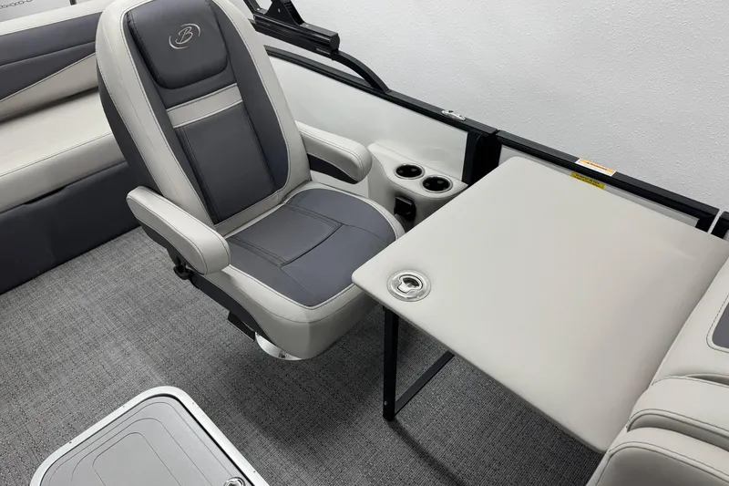 Slide: The Image of 2025 Barletta Cabrio 24UC interior with gray seating, table, and cup holders. - 20