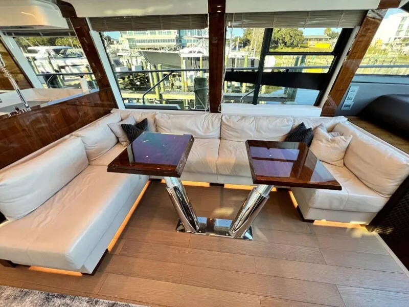 Slide: The Image of Luxurious interior of 2020 Fairline Squadron 68 yacht with plush seating and elegant tables. - 11