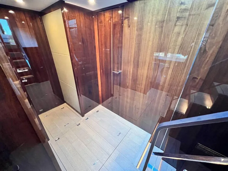 Slide: The Image of Luxurious interior of 2020 Fairline Squadron 68 yacht, featuring elegant wood paneling and modern design. - 21
