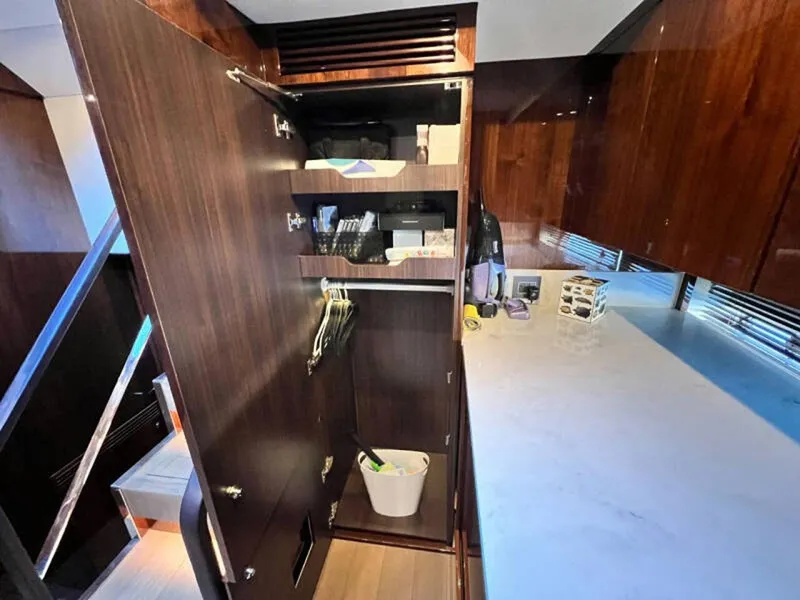Slide: The Image of Interior of 2020 Fairline Squadron 68 yacht with open wooden cabinet and countertop. - 34