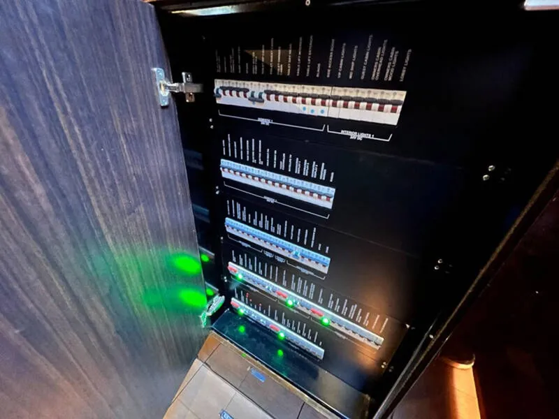 Slide: The Image of Electrical panel inside 2020 Fairline Squadron 68 yacht, showcasing circuit breakers and controls. - 40