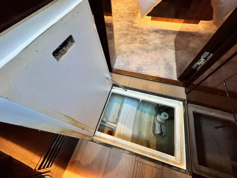 Slide: The Image of Open hatch on 2020 Fairline Squadron 68 yacht, revealing storage compartment. - 42