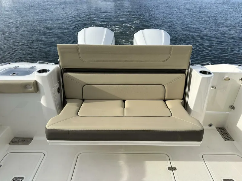 Slide: The Image of 2021 Pursuit DC 326 Dual Console boat with beige seating, on calm water. - 5