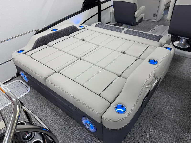 Slide: The Image of 2025 Barletta Lusso 25UC boat interior with luxurious seating and blue LED cup holders. - 10