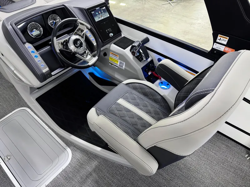 Slide: The Image of 2025 Barletta Lusso 25UC boat cockpit with modern steering and luxurious seating. - 12