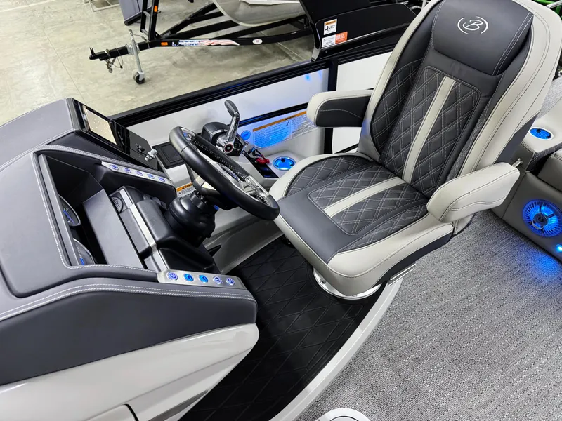 Slide: The Image of 2025 Barletta Lusso 25UC boat interior with luxurious captain's chair and modern dashboard. - 16