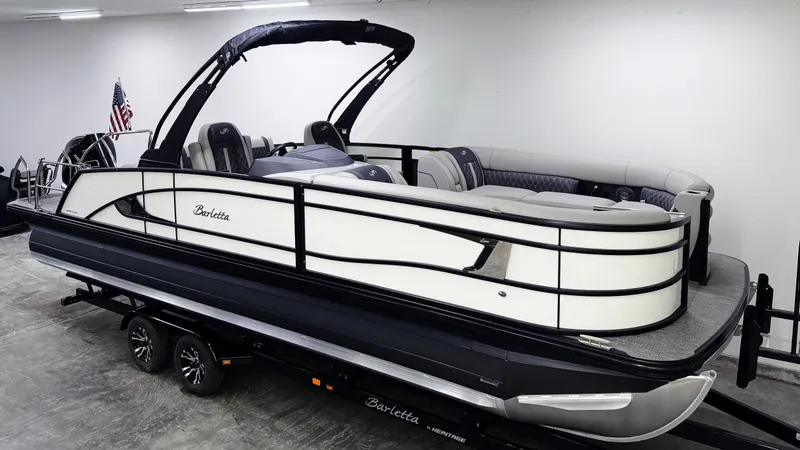Slide: The Image of 2025 Barletta Lusso 25UC pontoon boat on trailer in showroom. - 2