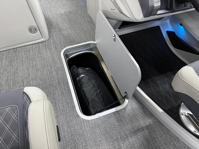 Slide: The Image of 2025 Barletta Lusso 25UC boat interior with open storage compartment and modern seating. - 24