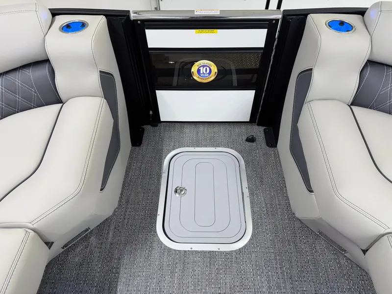 Slide: The Image of Interior of 2025 Barletta Lusso 25UC boat with plush seating and storage hatch. - 31