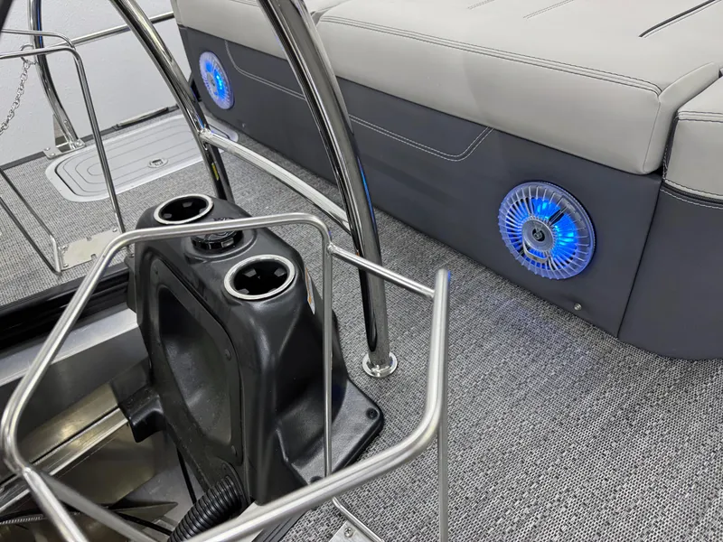 Slide: The Image of 2025 Barletta Lusso 25UC boat interior with cup holders and blue LED speaker lights. - 6