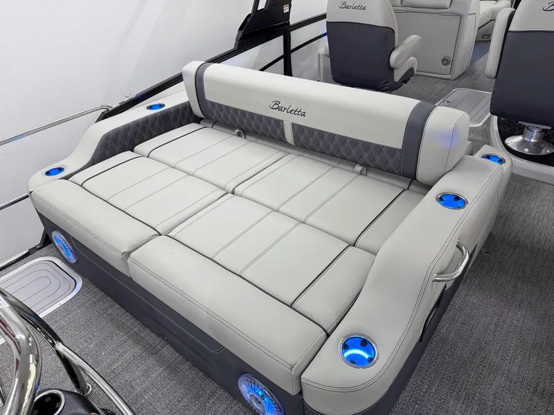 Slide: The Image of Luxurious seating on 2025 Barletta Lusso 25UC boat with cup holders and ambient lighting. - 7