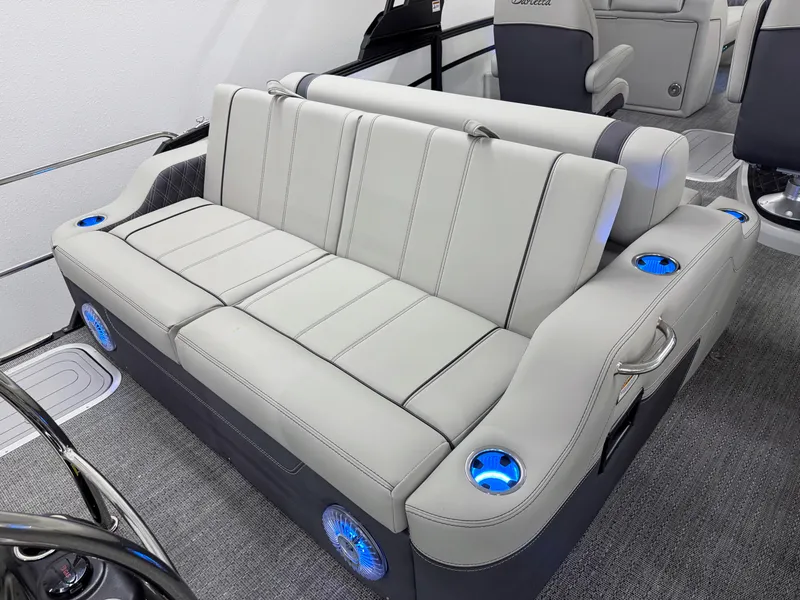 Slide: The Image of Luxurious seating on 2025 Barletta Lusso 25UC pontoon boat with cup holders and ambient lighting. - 8