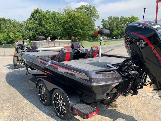 Slide: The Image of 2024 iKon LX20 boat with dual seats and powerful outboard motor, parked outdoors. - 5