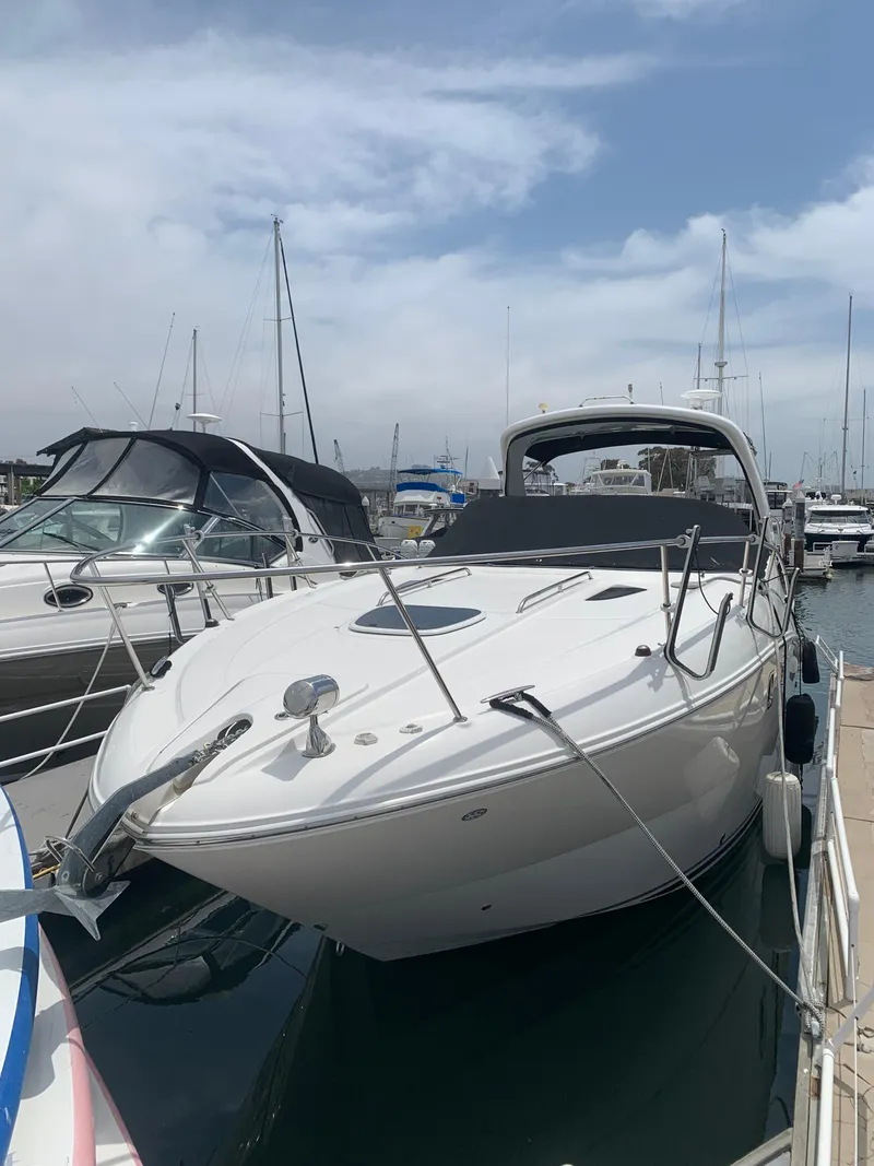 The Image of 2011 Sea Ray 330 Sundancer docked at marina under cloudy sky. - 0