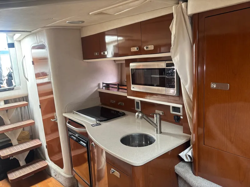 Slide: The Image of Interior of 2011 Sea Ray 330 Sundancer yacht with modern kitchen amenities. - 14