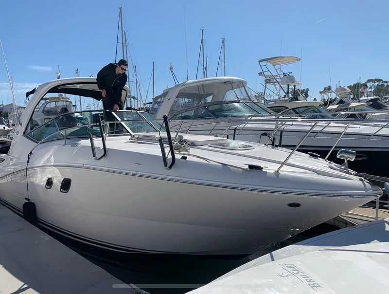 Slide: The Image of 2011 Sea Ray 330 Sundancer docked at marina under clear blue sky. - 15