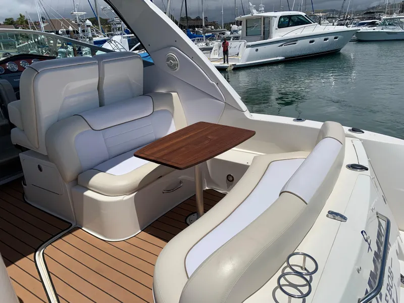 Slide: The Image of 2011 Sea Ray 330 Sundancer boat interior with seating and table, docked at marina. - 19