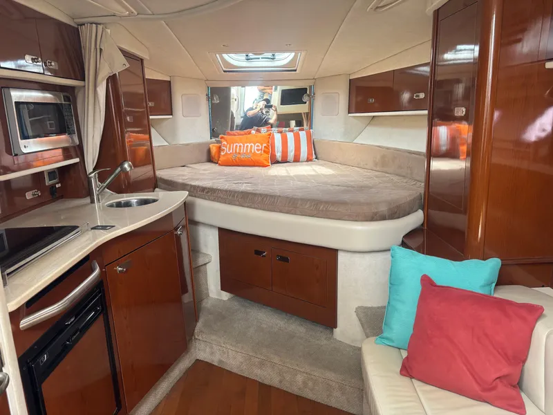 Slide: The Image of Interior of 2011 Sea Ray 330 Sundancer yacht with cozy bed and kitchenette. - 26