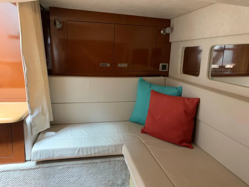 Slide: The Image of Interior cabin of 2011 Sea Ray 330 Sundancer with cushions and wooden cabinetry. - 27
