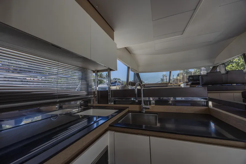Slide: The Image of Modern kitchen interior of 2018 Prestige 520 yacht with sleek countertops and large windows. - 10