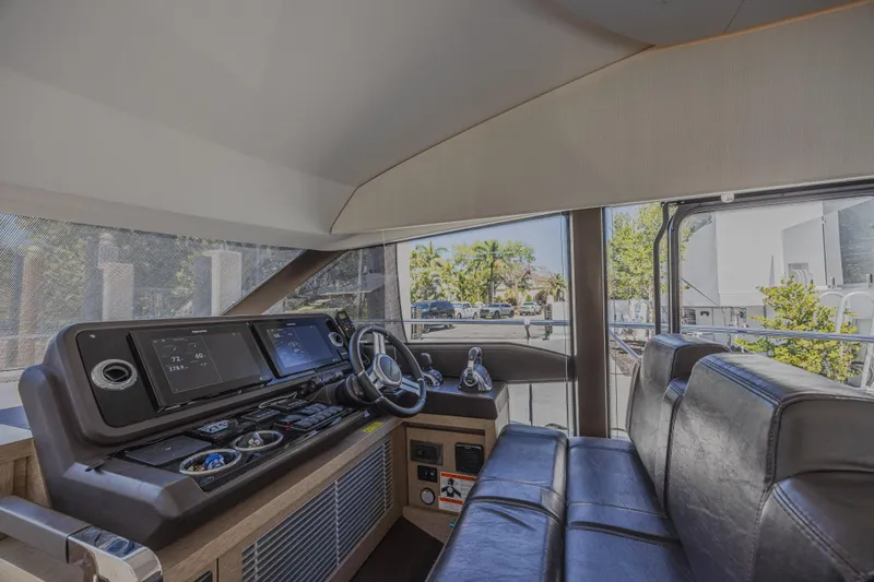 Slide: The Image of Interior of a 2018 Prestige 520 yacht, featuring a modern helm and seating area. - 17