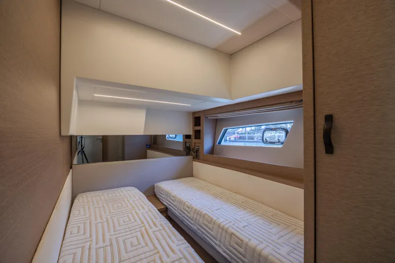 Slide: The Image of Interior of 2018 Prestige 520 yacht with twin beds and window view. - 21