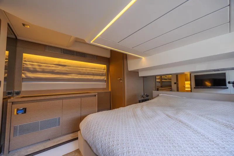 Slide: The Image of Luxurious interior of a 2018 Prestige 520 yacht bedroom with modern lighting and elegant design. - 29