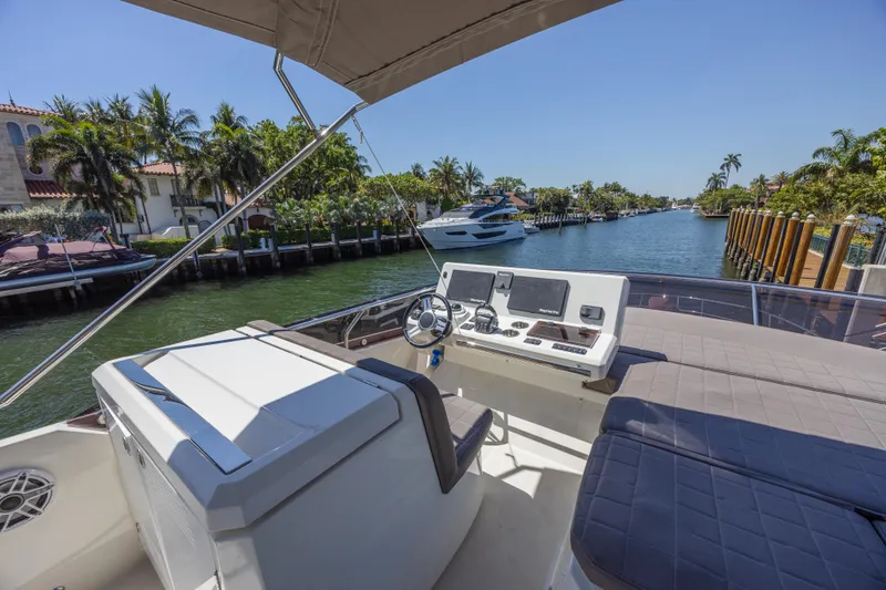 Slide: The Image of Flybridge view of 2018 Prestige 520 yacht on a sunny canal. - 41