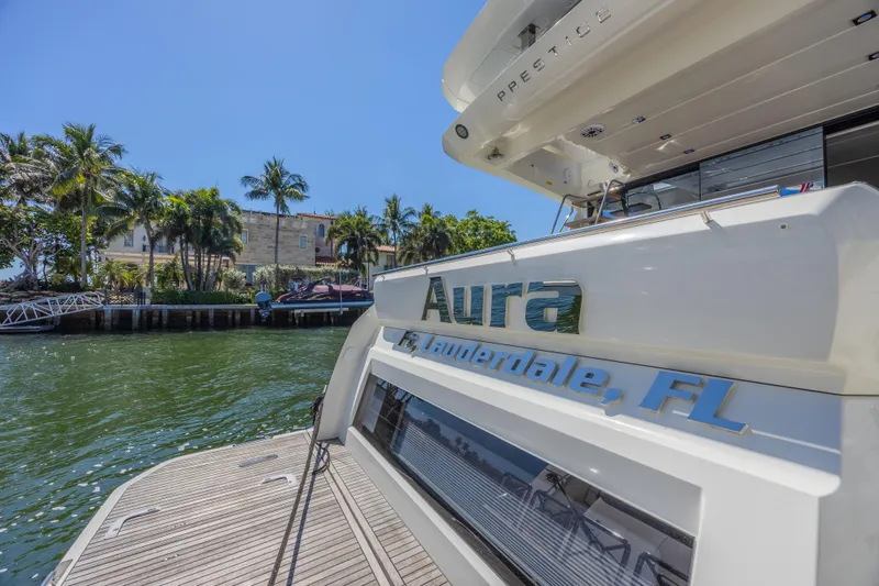 Slide: The Image of 2018 Prestige 520 yacht docked in Fort Lauderdale, FL, with palm trees in the background. - 43