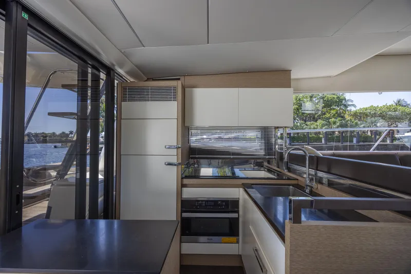 Slide: The Image of Modern kitchen interior on 2018 Prestige 520 yacht, featuring sleek cabinetry and appliances. - 8